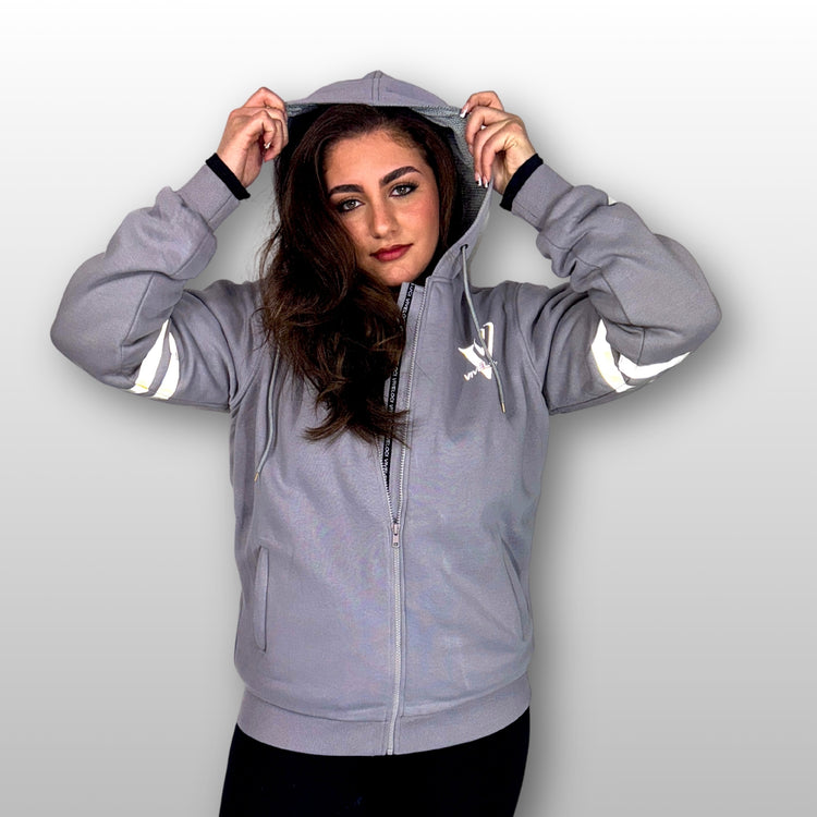 Bernadette is wearing a ViVeloci Kevlar Lined, Armored, Motorcycle Hoodie in Silver Grey.  Reflective back, front and arm bands.  Removable CE Level 1 Armor in Shoulders, Elbows and Back. Two zippered pockets on the outside and one on the inside.