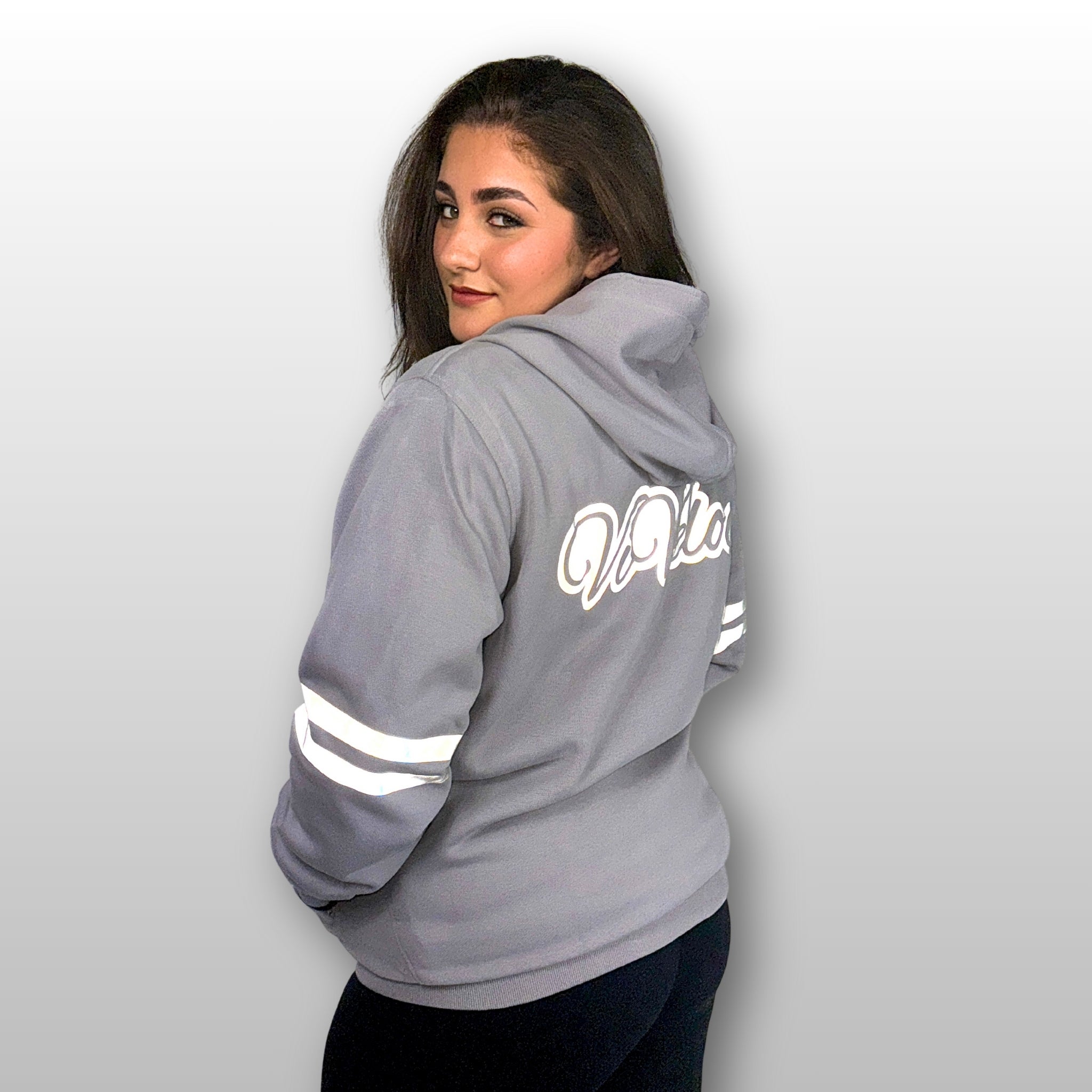 Bernadette is wearing a ViVeloci Kevlar Lined, Armored, Motorcycle Hoodie in Silver Grey.  Reflective back, front and arm bands.  Removable CE Level 1 Armor in Shoulders, Elbows and Back. Two zippered pockets on the outside and one on the inside.