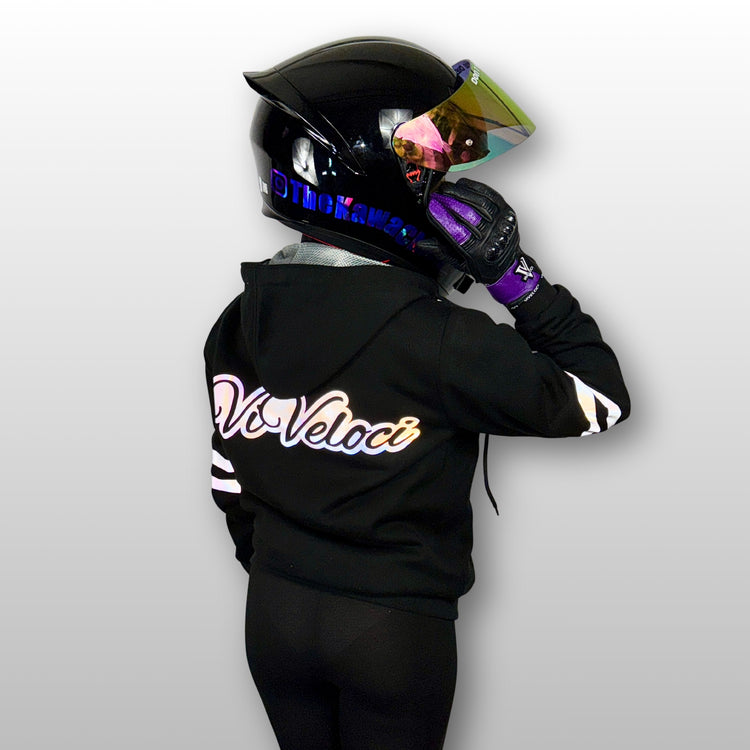 Aaliyah is wearing a black ViVeloci Kevlar Lined, Armored, Motorcycle Hoodie.  Reflective back, front and arm bands.  Removable CE Level 1 Armor in Shoulders, Elbows and Back. Two zippered pockets on the outside and one on the inside.