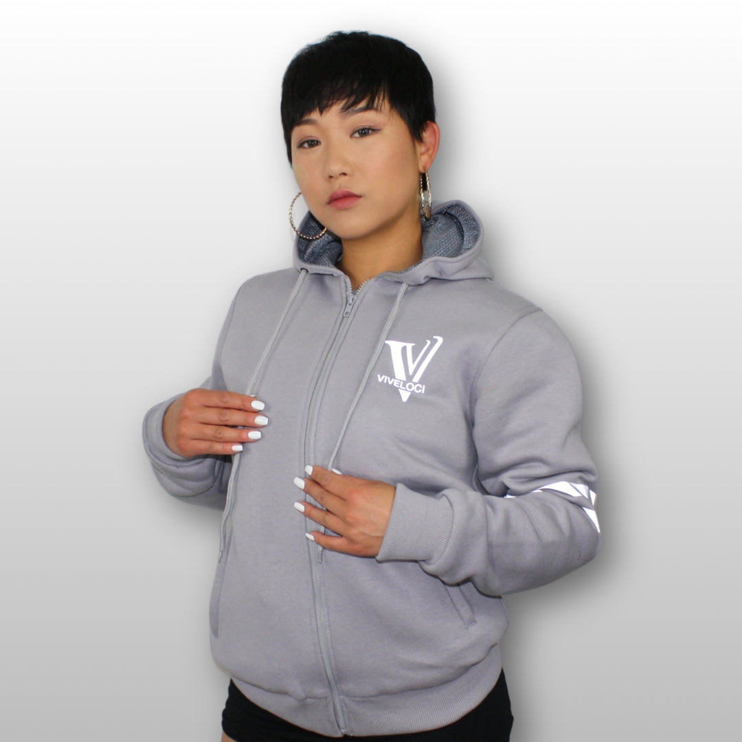 Hanna is wearing a ViVeloci Kevlar Lined, Armored, Motorcycle Hoodie in Silver Grey.  Reflective back, front and arm bands.  Removable CE Level 1 Armor in Shoulders, Elbows and Back. Two zippered pockets on the outside and one on the inside.