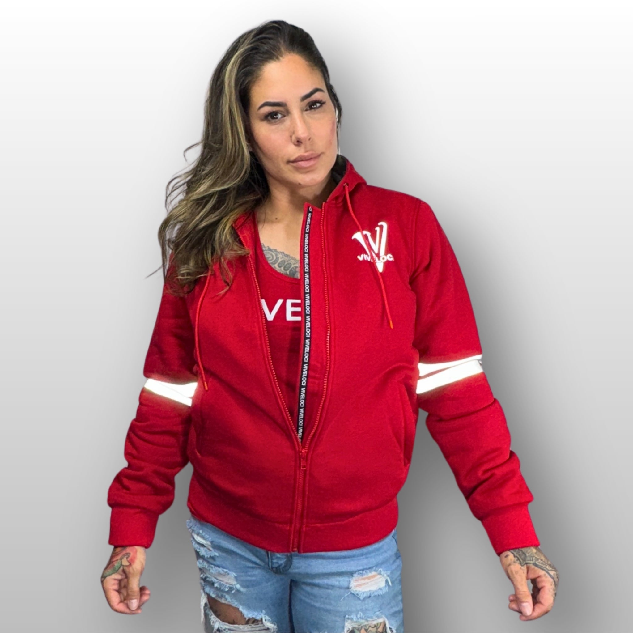 Nina is wearing a ViVeloci Kevlar Lined, Armored, Motorcycle Hoodie in Red.  Reflective back, front and arm bands.  Removable CE Level 1 Armor in Shoulders, Elbows and Back. Two zippered pockets on the outside and one on the inside.