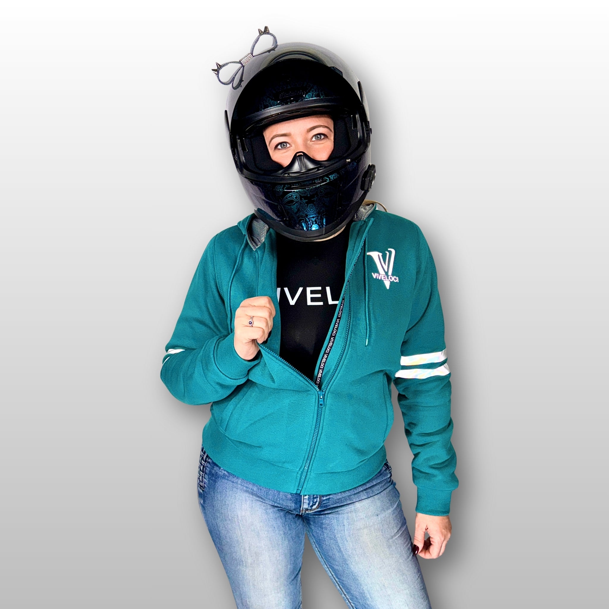 Amy is wearing a ViVeloci Kevlar Lined, Armored, Motorcycle Hoodie in Teal.  Reflective back, front and arm bands.  Removable CE Level 1 Armor in Shoulders, Elbows and Back. Two zippered pockets on the outside and one on the inside.