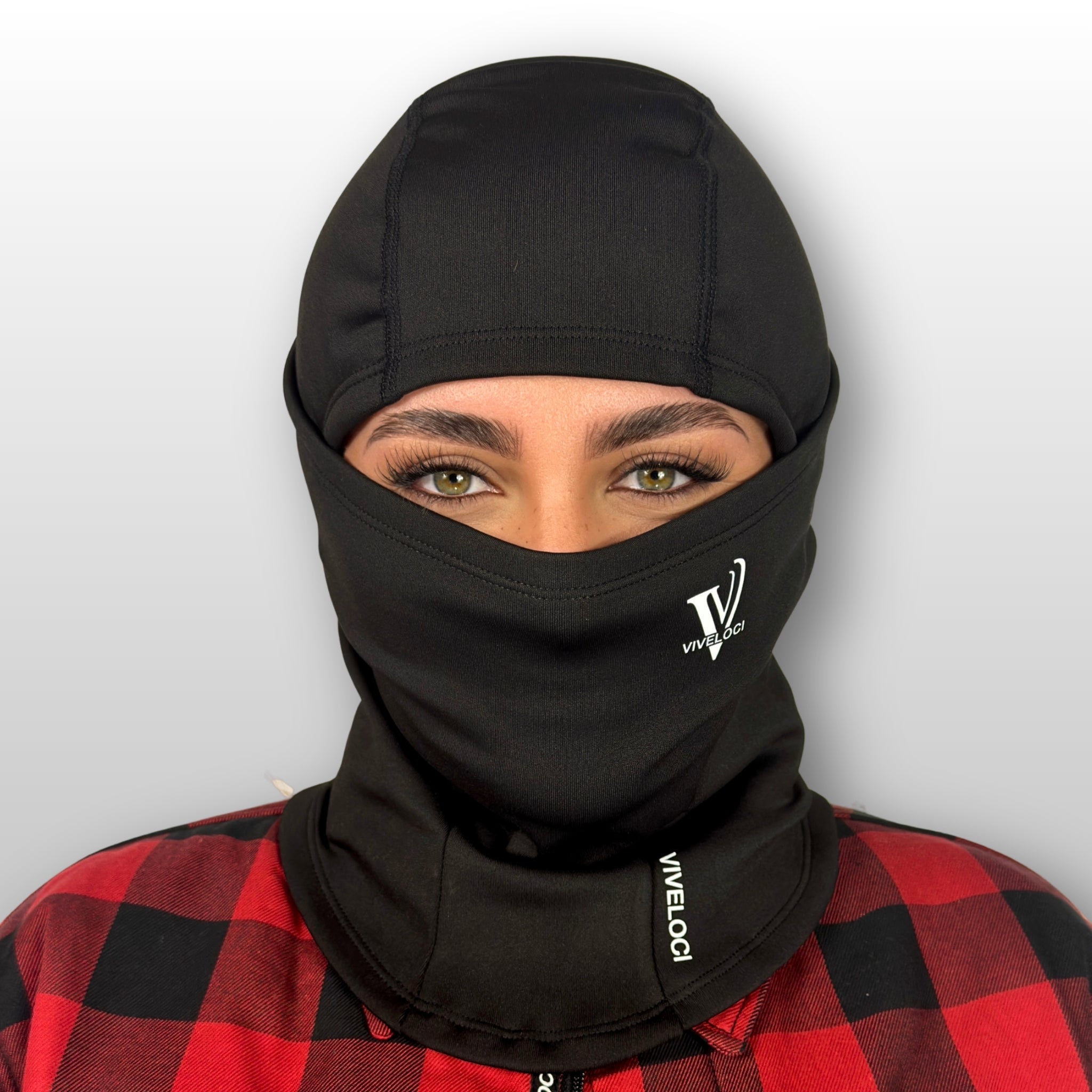 Bernadette wearing a black Viveloci balaclava with a visible brand logo on a plain background