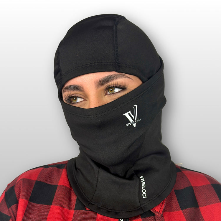 Bernadette wearing a black Viveloci balaclava with a visible brand logo on a plain background