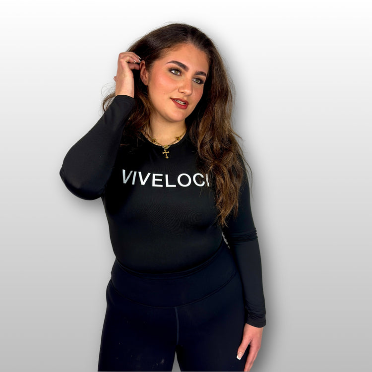 Bernadette wearing a black long-sleeve bodysuit with 'VIVELOCI' text on a plain background