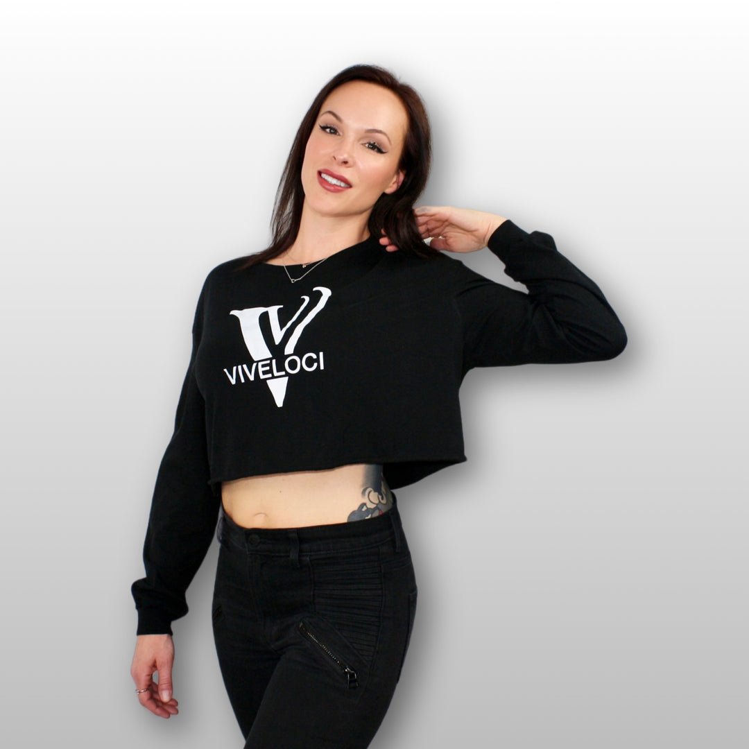 Tiffani wearing a black ViVeloci long sleeved crop top against a grey background.