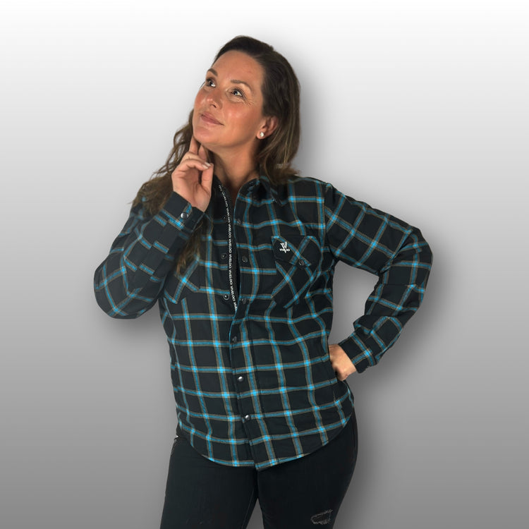 Deanna wearing teal and black Armored Riding Flannel