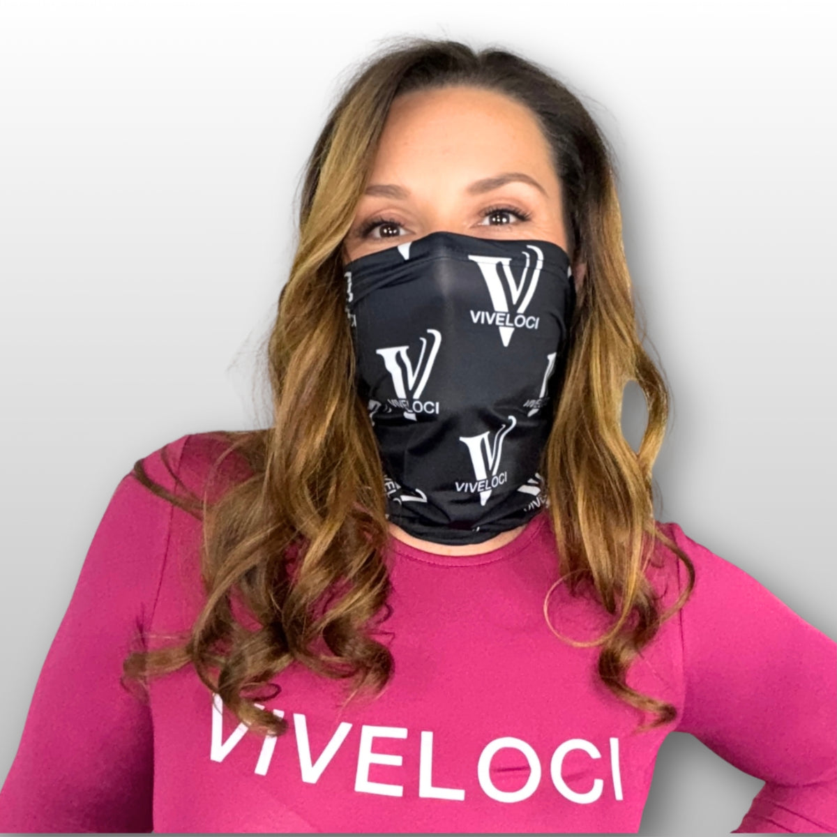 Deanna wearing a black VIVELOCI gaiter and pink bodysuit 