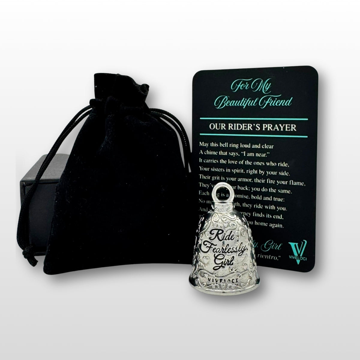 Silver bell with 'Ride Fearlessly Girl' text, black pouch, and prayer card on a white background