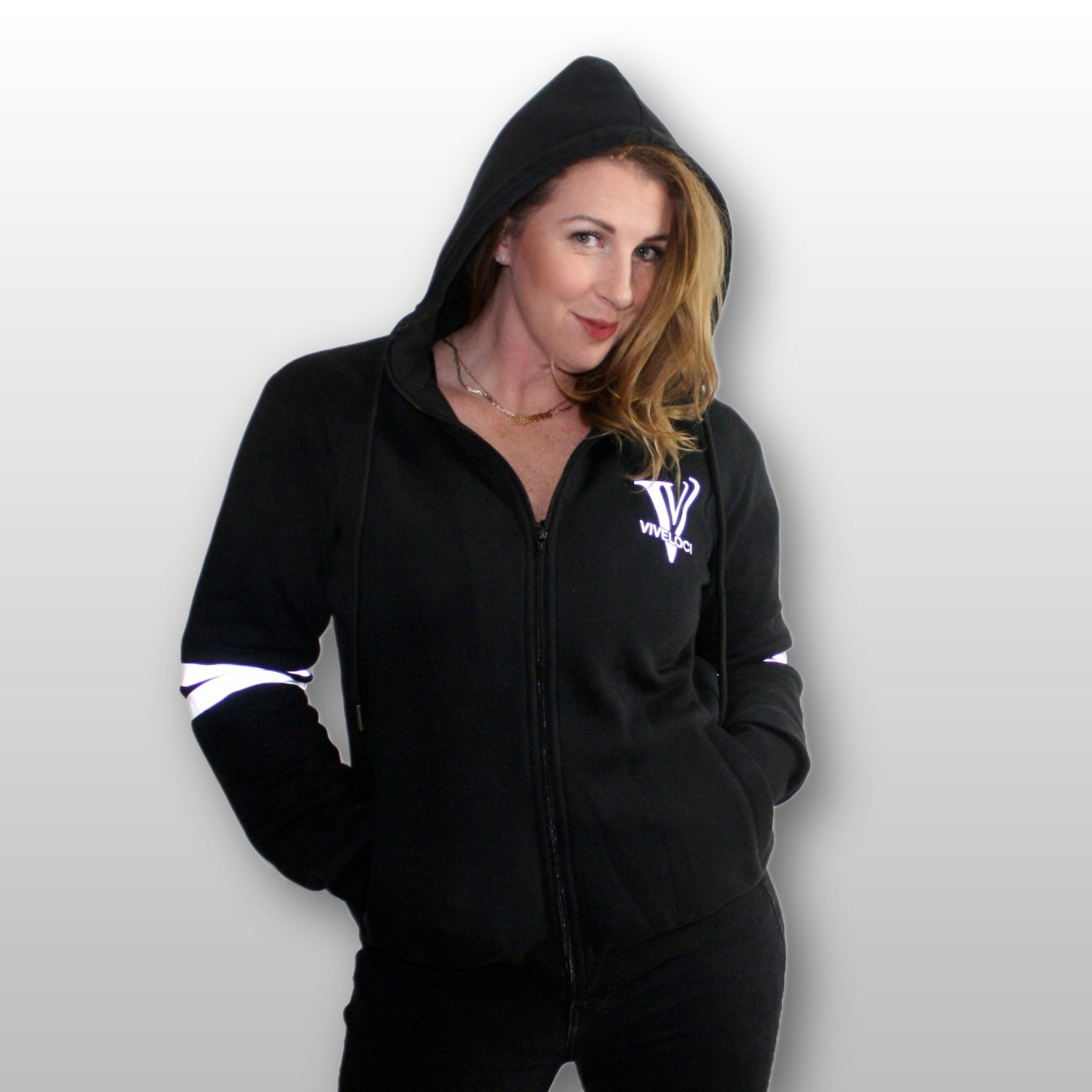 Chrissie is wearing a black ViVeloci Kevlar Lined, Armored, Motorcycle Hoodie. Reflective back, front and arm bands.  Removable CE Level 1 Armor in Shoulders, Elbows and Back. Two zippered pockets on the outside and one on the inside.