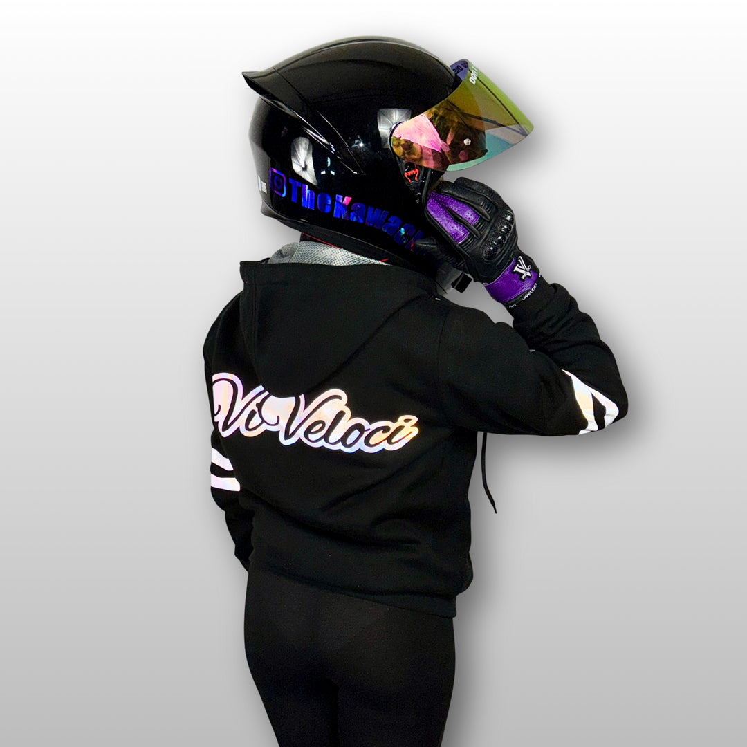 Aaliyah is wearing a black ViVeloci Kevlar Lined, Armored, Motorcycle Hoodie.  Reflective back, front and arm bands.  Removable CE Level 1 Armor in Shoulders, Elbows and Back. Two zippered pockets on the outside and one on the inside.