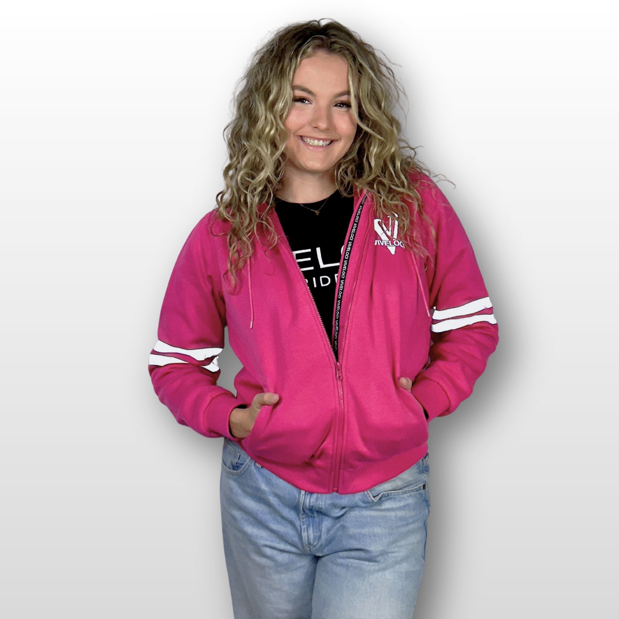 Emily is wearing a ViVeloci Kevlar Lined, Armored, Motorcycle Hoodie in Pink.  Reflective back, front and arm bands.  Removable CE Level 1 Armor in Shoulders, Elbows and Back. Two zippered pockets on the outside and one on the inside.