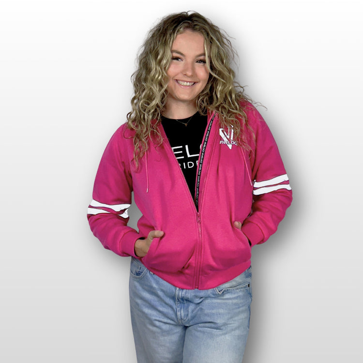 Emily is wearing a ViVeloci Kevlar Lined, Armored, Motorcycle Hoodie in Pink.  Reflective back, front and arm bands.  Removable CE Level 1 Armor in Shoulders, Elbows and Back. Two zippered pockets on the outside and one on the inside.