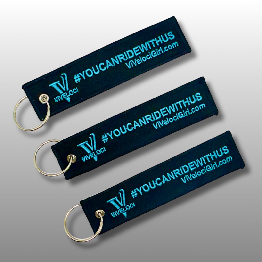 Viveloci You can ride with us key tag/key chains. Black fabric with teal embroidered lettering.