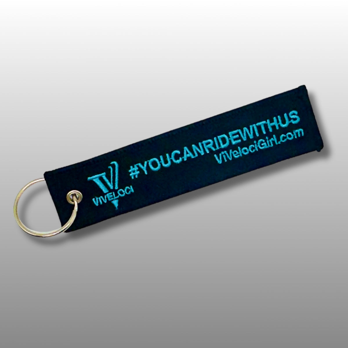Viveloci You can ride with us key tag/key chains. Black fabric with teal embroidered lettering.