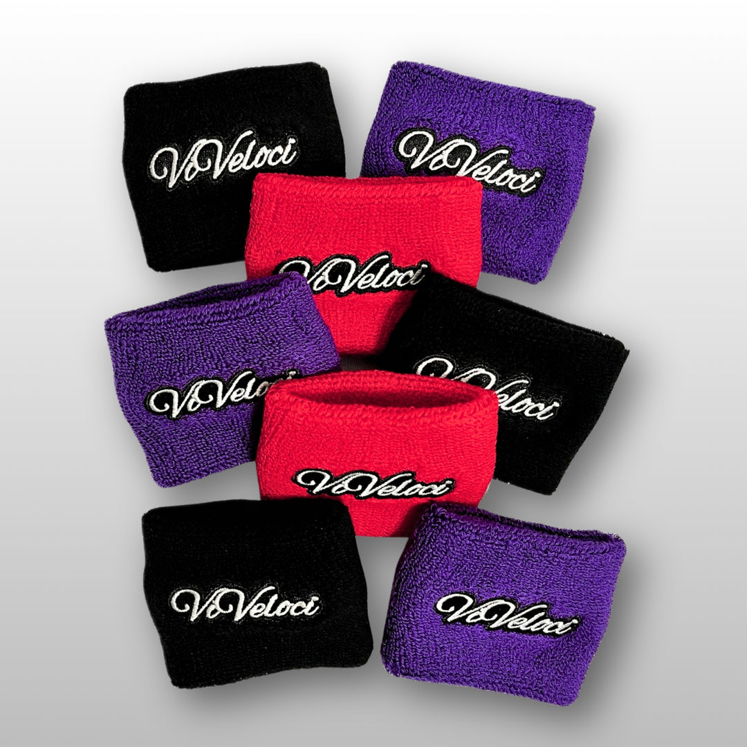 Various ViVeloci reservoir covers in black, red, and purple on a light gray background.