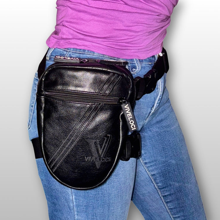 Black leather leg bag with visible ViVeloci branding worn by a woman in blue jeans