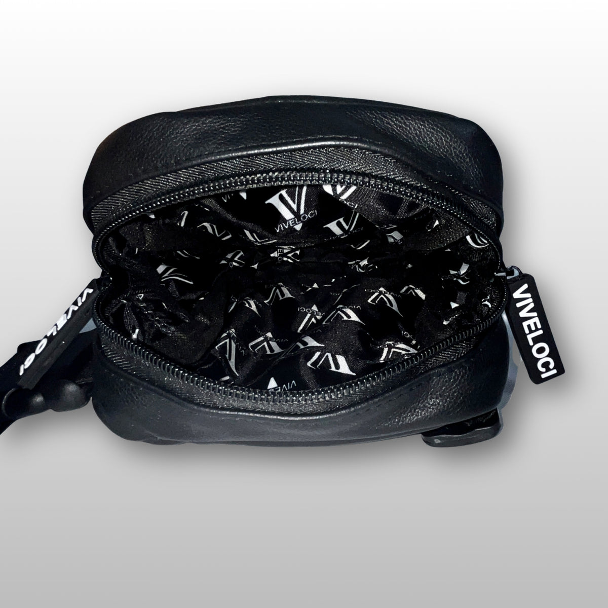 Interior view of black leather thigh bag with  visible 'Viveloci' branding on the lining