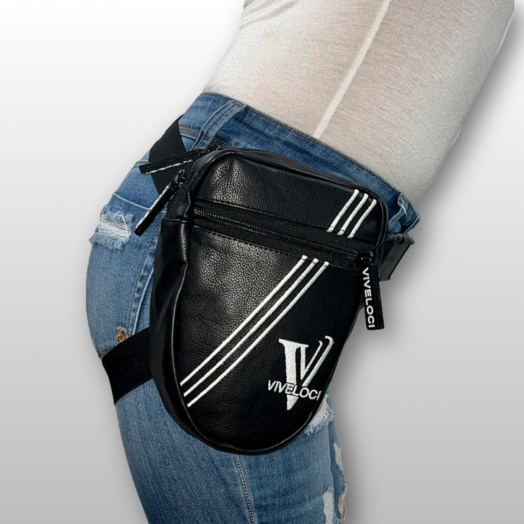 Black leather thigh bag with white stripes and 'Viveloci' logo worn by a woman in jeans.