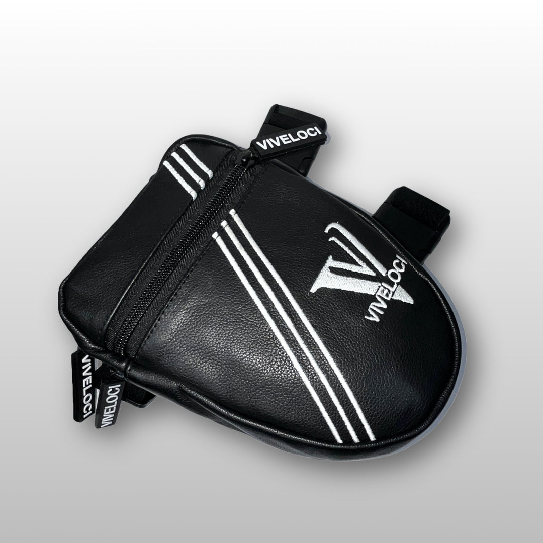 Black leather thigh bag with white stripes and 'ViVeloci' branding on a light gray background