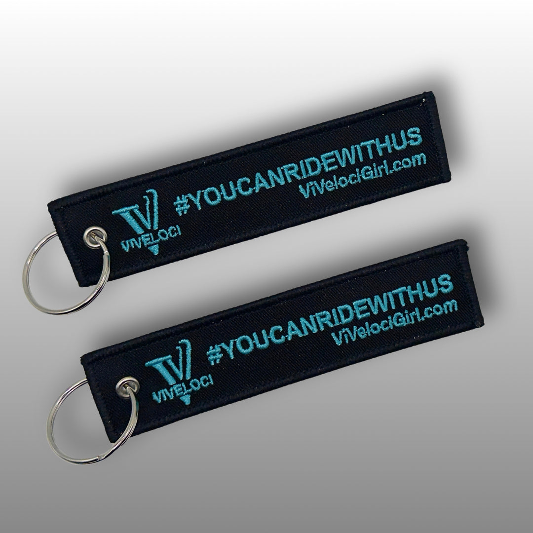 Viveloci You can ride with us key tag/key chains. Black with teal embroidered lettering.